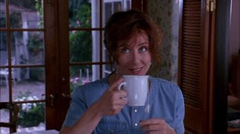 Movie still from “Blue Chips” (1994), directed by William Friedkin – A person holding a cup of coffee; Medium shot, Over the shoulder angle