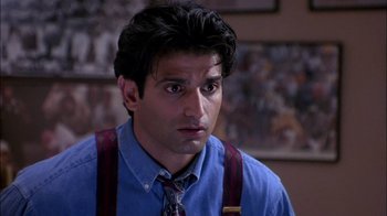 Movie still from “Blue Chips” (1994), directed by William Friedkin – A person wearing suspenders; Close Up shot, High angle