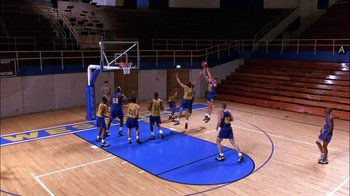 Movie still from “Blue Chips” (1994), directed by William Friedkin – A group of young men playing a game of basketball on an indoor court; Extreme Wide shot, Overhead angle