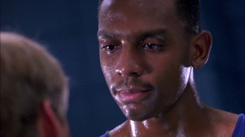 Movie still from “Blue Chips” (1994), directed by William Friedkin – A person with sweat on his face; Close Up shot, Over the shoulder angle