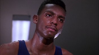 Movie still from “Blue Chips” (1994), directed by William Friedkin – A person wearing a tank top; Close Up shot, Low angle