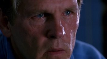 Movie still from “Blue Chips” (1994), directed by William Friedkin – A man's eyes and face; Close Up shot, Low angle
