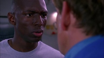Movie still from “Blue Chips” (1994), directed by William Friedkin – Two men are facing each other and one has his mouth wide open; Close Up shot, Over the shoulder angle
