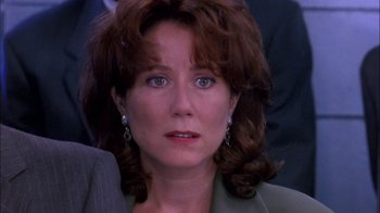 Movie still from “Blue Chips” (1994), directed by William Friedkin – A person wearing a suit; Close Up shot, Over the shoulder angle