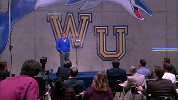 Movie still from “Blue Chips” (1994), directed by William Friedkin – A man standing in front of a group of people; Wide shot, High angle