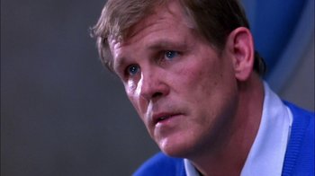 Movie still from “Blue Chips” (1994), directed by William Friedkin – A person wearing a suit and tie; Close Up shot, Low angle