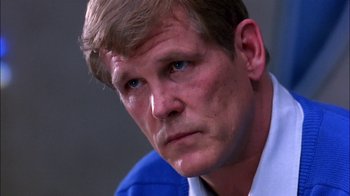 Movie still from “Blue Chips” (1994), directed by William Friedkin – A person wearing a blue shirt; Close Up shot, Low angle