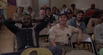 Movie still from “Blue Collar” (1978), directed by Paul Schrader – A group of people sitting in chairs in a room; Medium shot, High angle