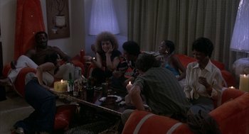 Movie still from “Blue Collar” (1978), directed by Paul Schrader – A group of people sitting around a living room table; Wide shot, High angle