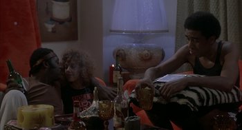 Movie still from “Blue Collar” (1978), directed by Paul Schrader – A group of people sitting at a table with drinks; Medium shot, Over the shoulder angle