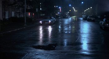 Movie still from “Blue Collar” (1978), directed by Paul Schrader – A car driving down a street at night; Extreme Wide shot, High angle