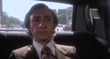 Movie still from “Blue Collar” (1978), directed by Paul Schrader – A man sitting in the back seat of a car; Close Up shot, Low angle