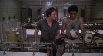 Movie still from “Blue Collar” (1978), directed by Paul Schrader – Two men working in an industrial setting with pipes; Medium shot, Low angle