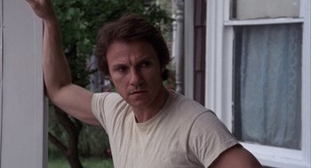Movie still from “Blue Collar” (1978), directed by Paul Schrader – A person wearing a white t - shirt; Close Up shot, Low angle