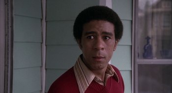 Movie still from “Blue Collar” (1978), directed by Paul Schrader – A man in a red sweater and striped shirt; Close Up shot, Low angle