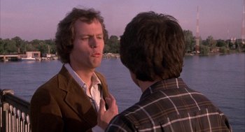 Movie still from “Blue Collar” (1978), directed by Paul Schrader – Two men standing next to each other near a body of water; Close Up shot, Over the shoulder angle