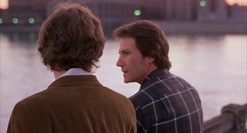 Movie still from “Blue Collar” (1978), directed by Paul Schrader – Two men standing next to each other near a body of water; Close Up shot, Over the shoulder angle