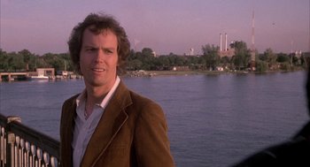 Movie still from “Blue Collar” (1978), directed by Paul Schrader – A man standing in front of a body of water; Close Up shot, Over the shoulder angle