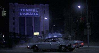 Movie still from “Blue Collar” (1978), directed by Paul Schrader – A car parked on the side of the road at night; Wide shot, Low angle