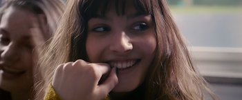 Movie still from “Blue Is the Warmest Colour” (2013), directed by Abdellatif Kechiche – A person smiling with her fingers in her mouth; Close Up shot, Low angle