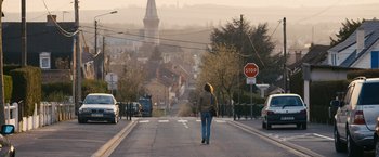 Movie still from “Blue Is the Warmest Colour” (2013), directed by Abdellatif Kechiche – A woman walking down the middle of a street; Extreme Wide shot, Low angle