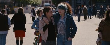 Movie still from “Blue Is the Warmest Colour” (2013), directed by Abdellatif Kechiche – Two young people walking down a street talking to each other; Medium shot, Over the shoulder angle