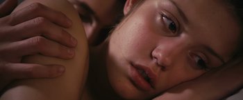 Movie still from “Blue Is the Warmest Colour” (2013), directed by Abdellatif Kechiche – A young woman's face with her hand resting on her chest; Close Up shot, Low angle