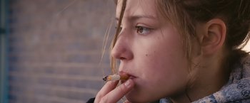 Movie still from “Blue Is the Warmest Colour” (2013), directed by Abdellatif Kechiche – A young girl is smoking a cigarette; Close Up shot, Low angle