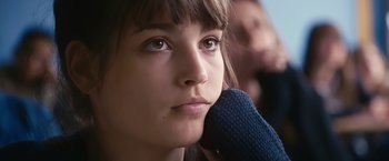 Movie still from “Blue Is the Warmest Colour” (2013), directed by Abdellatif Kechiche – A woman with a microphone in her hand; Close Up shot, Low angle