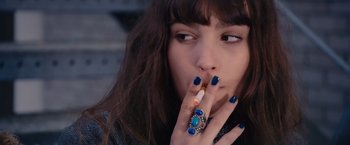 Movie still from “Blue Is the Warmest Colour” (2013), directed by Abdellatif Kechiche – A woman smoking a cigarette while wearing blue nails; Close Up shot, High angle