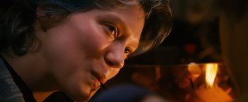 Movie still from “Blue Is the Warmest Colour” (2013), directed by Abdellatif Kechiche – A person's face with a cigarette in their mouth; Close Up shot, Low angle