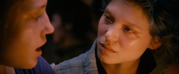Movie still from “Blue Is the Warmest Colour” (2013), directed by Abdellatif Kechiche – A person's face in a dark room; Close Up shot, Over the shoulder angle