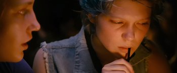 Movie still from “Blue Is the Warmest Colour” (2013), directed by Abdellatif Kechiche – A woman with blue hair is looking down; Close Up shot, High angle