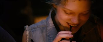 Movie still from “Blue Is the Warmest Colour” (2013), directed by Abdellatif Kechiche – A person holding a pen in their hand; Extreme Close Up shot, High angle