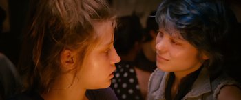 Movie still from “Blue Is the Warmest Colour” (2013), directed by Abdellatif Kechiche – Two people are looking at each other in a room; Close Up shot, Over the shoulder angle