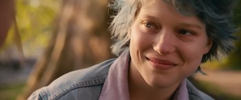 Movie still from “Blue Is the Warmest Colour” (2013), directed by Abdellatif Kechiche – A person with a blue jacket on; Close Up shot, Over the shoulder angle