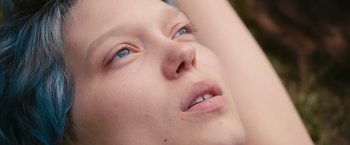 Movie still from “Blue Is the Warmest Colour” (2013), directed by Abdellatif Kechiche – A person's face with blue eyes; Extreme Close Up shot, Overhead angle
