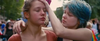 Movie still from “Blue Is the Warmest Colour” (2013), directed by Abdellatif Kechiche – Two young women with blue hair touching their heads; Close Up shot, Over the shoulder angle