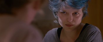 Movie still from “Blue Is the Warmest Colour” (2013), directed by Abdellatif Kechiche – A person with blue hair; Close Up shot, Over the shoulder angle