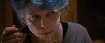 Movie still from “Blue Is the Warmest Colour” (2013), directed by Abdellatif Kechiche – A person with blue hair is holding a straw in her mouth; Close Up shot, Low angle