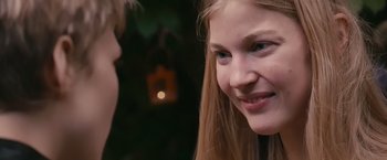 Movie still from “Blue Is the Warmest Colour” (2013), directed by Abdellatif Kechiche – A young woman smiles at a young man; Close Up shot, Over the shoulder angle