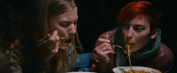 Movie still from “Blue Is the Warmest Colour” (2013), directed by Abdellatif Kechiche – Two people sitting at a dinner table eating food; Close Up shot, High angle