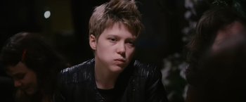 Movie still from “Blue Is the Warmest Colour” (2013), directed by Abdellatif Kechiche – A young man with spiky brown hair wearing a black jacket; Close Up shot, High angle