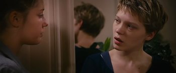 Movie still from “Blue Is the Warmest Colour” (2013), directed by Abdellatif Kechiche – A young woman looking in the mirror in front of a mirror; Close Up shot, Over the shoulder angle