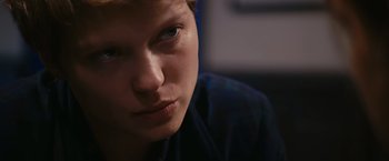 Movie still from “Blue Is the Warmest Colour” (2013), directed by Abdellatif Kechiche – A young man's face in the dark; Close Up shot, Low angle