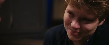 Movie still from “Blue Is the Warmest Colour” (2013), directed by Abdellatif Kechiche – A person smiling; Close Up shot, Over the shoulder angle