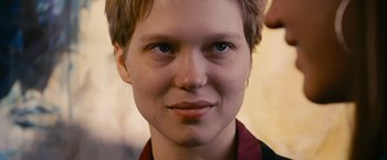 Movie still from “Blue Is the Warmest Colour” (2013), directed by Abdellatif Kechiche – A person's face with blue eyes; Close Up shot, Over the shoulder angle