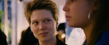 Movie still from “Blue Is the Warmest Colour” (2013), directed by Abdellatif Kechiche – A woman with short brown hair is looking at another woman with short brown hair; Close Up shot, Over the shoulder angle