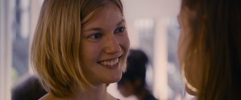 Movie still from “Blue Is the Warmest Colour” (2013), directed by Abdellatif Kechiche – A person smiling; Close Up shot, Over the shoulder angle