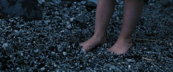 Movie still from “Blue My Mind” (2017), directed by Lisa Brühlmann – A person's bare feet on the ground; Extreme Close Up shot, High angle